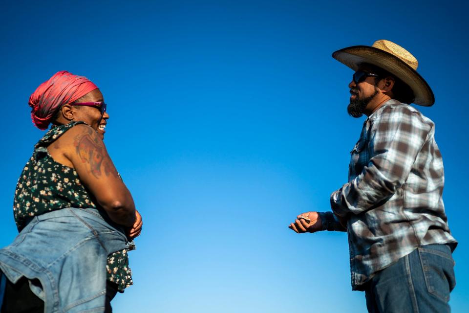 Nelli Evans, left, and Brian Cano, right, joke around as they take a break from working at Food Forest Cooperative on March 17, 2022, in Phoenix. The farm co-op is a 1.5-acre plot of land located on Spaces of Opportunity in south Phoenix.