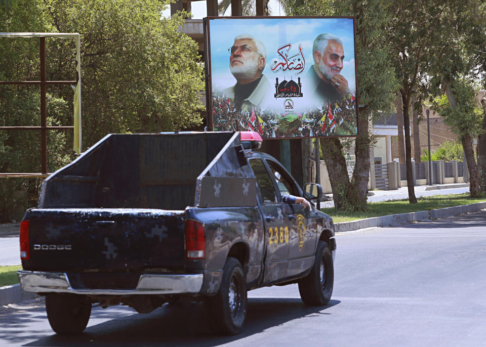 A poster of killed militia with Popular Mobilization militia is seen in Baghdad, Iraq, Friday, June 26, 2020. Iraqi security forces arrested over a dozen men suspected of a spate of rocket attacks against the U.S. (AP Photo/Hadi Mizban)