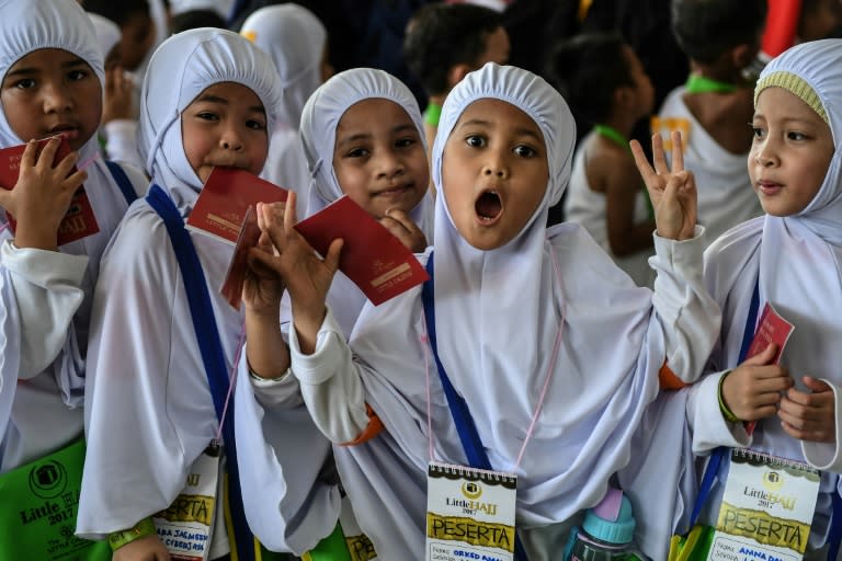 About 4,000 six year olds, dressed in white robes of the kind worn by pilgrims and carrying green bags, participated in the "Little Hajj" event in a field outside the capital Kuala Lumpur