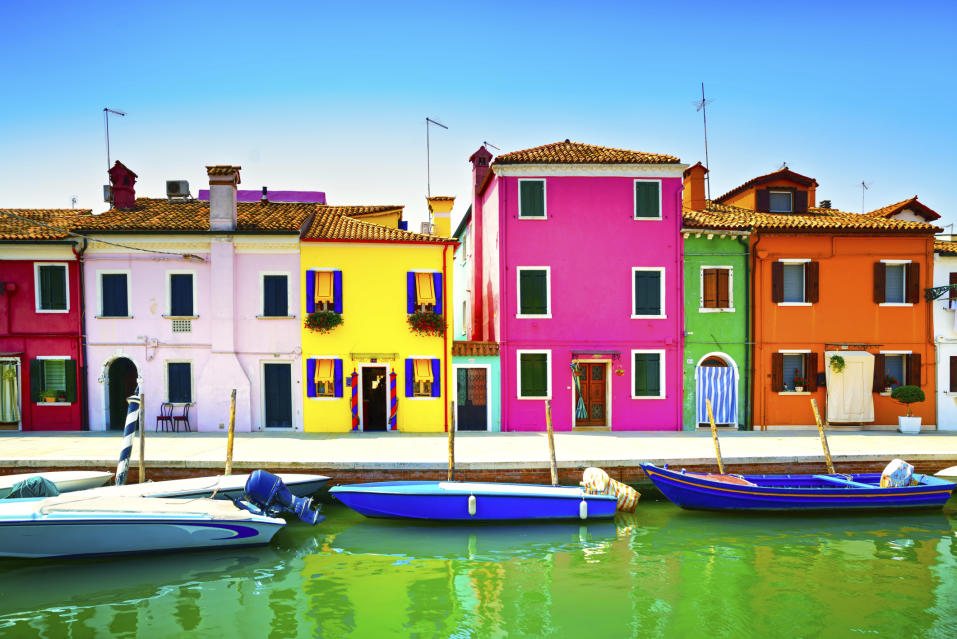 Venice landmark, Burano island canal, colorful houses and boats,