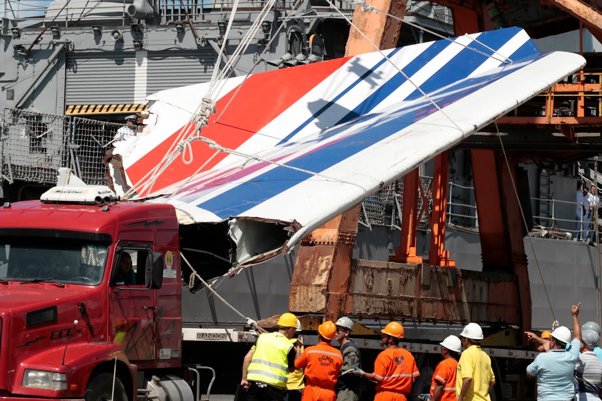 Workers unloading debris, belonging to crashed Air France flight AF447, from the Brazilian Navy’s Constitution Frigate in the port of Recife, northeast of Brazil, on June 14, 2009 (AP)