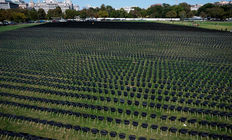 Empty chairs are on display to represent the 200,000 lives lost due to COVID-19 at the National Covid-19 Remembrance, on the ellipse behind the White House in Washington, DC on October 4, 2020.