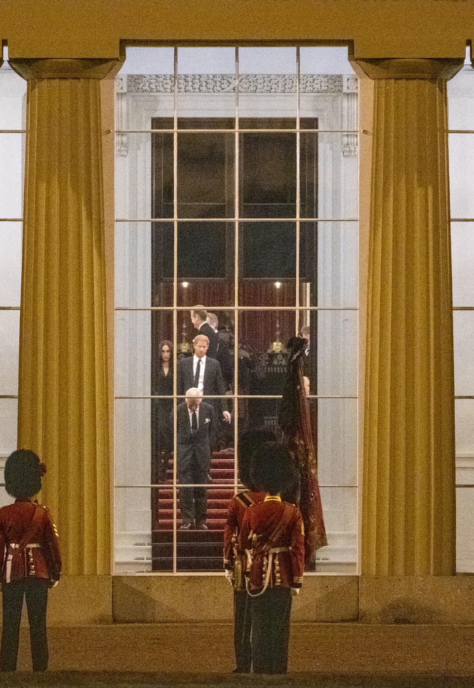 King Charles, Prince Harry and Meghan Markle walking in Buckingham Palace