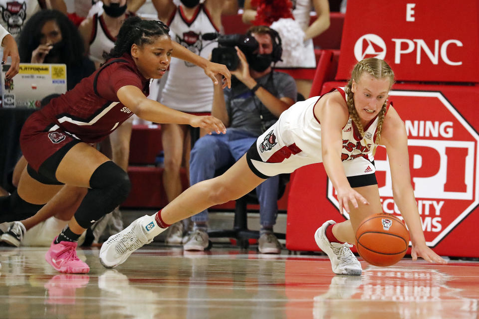 North Carolina State's Elissa Cunane, right, dives for the loose ball in front of North Carolina State's Genesis Bryant (1) during the second half of an NCAA college basketball game Tuesday, Nov. 9, 2021, in Raleigh, N.C. (AP Photo/Karl B. DeBlaker)