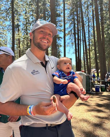 <p>Josh Allen/Instagram</p> Josh Allen smiles while holding his sister's baby at a golf competition in California