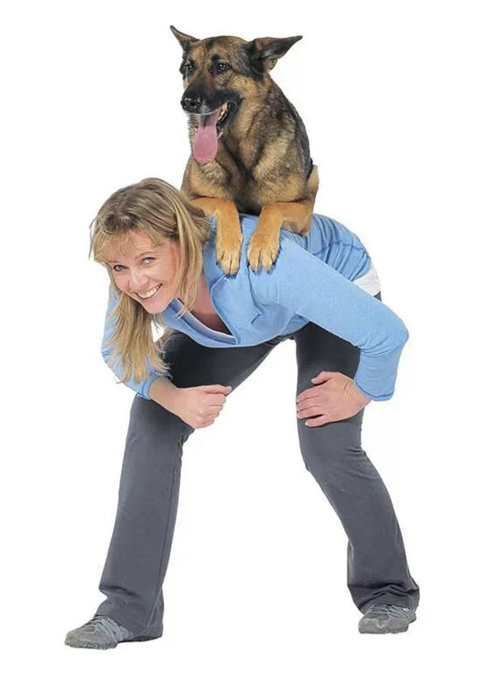 This undated image provided by Trina Kaye shows Babette Haggerty, the author of “The Best Dog Tricks on the Planet,” with a German shepherd named Steve sitting on her back. Haggerty, veteran dog trainer to the stars, has packed 106 teach-them-yourself stunts into her new book, "The Best Dog Tricks on the Planet." (AP Photo/Trina Kaye)