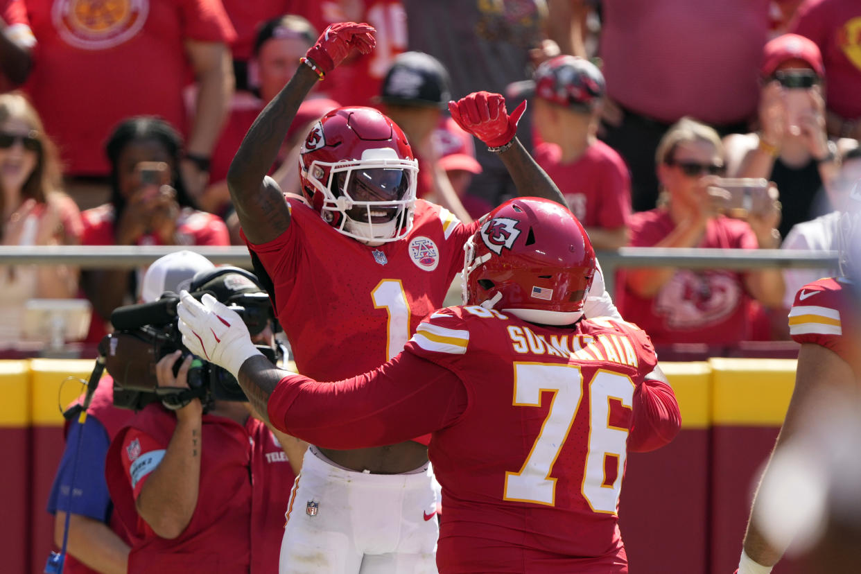 Kansas City Chiefs wide receiver Xavier Worthy (1) celebrates his touchdown catch against the Detroit Lions with teammate Kingsley Suamataia (76). (AP Photo/Charlie Riedel)