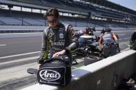 Pato O'Ward, of Mexico, puts away his helmet following practice for the Indianapolis 500 auto race at Indianapolis Motor Speedway, Monday, May 22, 2023, in Indianapolis. (AP Photo/Darron Cummings)