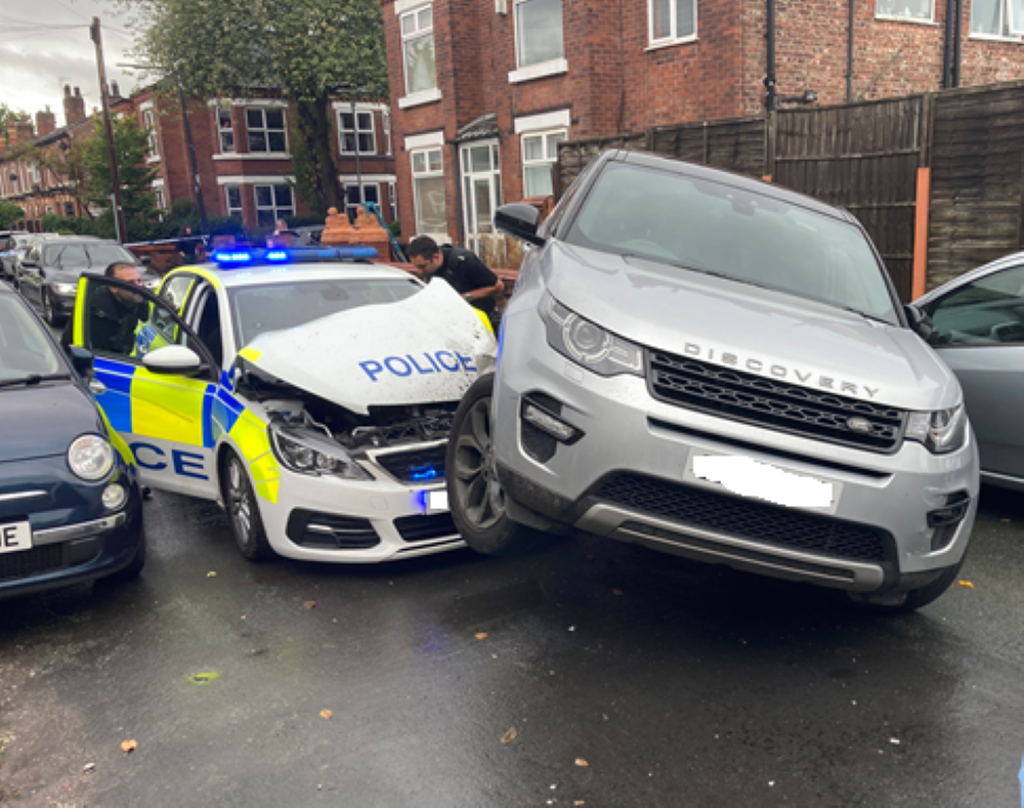 A police car which was rammed by a Land Rover during a chase in Trafford (Greater Manchester Police/PA)