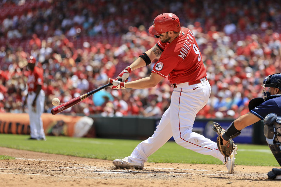 Cincinnati Reds' Mike Moustakas hits a two-run home run during the third inning of a baseball game against the Tampa Bay Rays in Cincinnati, Sunday, July 10, 2022. (AP Photo/Aaron Doster)