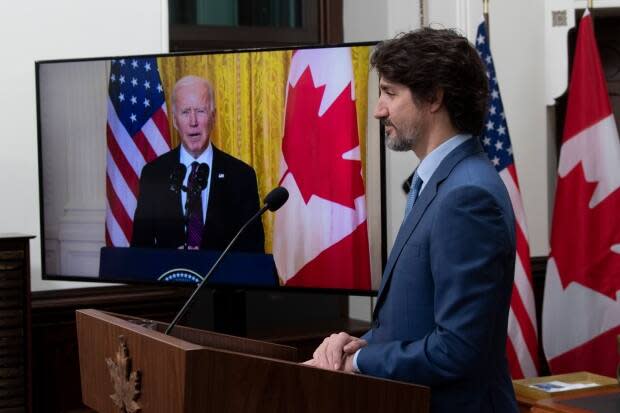 Prime Minister Justin Trudeau looks at a television screen as he listens to United States President Joe Biden speak during a virtual joint statement after a virtual meeting in Ottawa, Tuesday, February 23, 2021. (The Canadian Press - image credit)