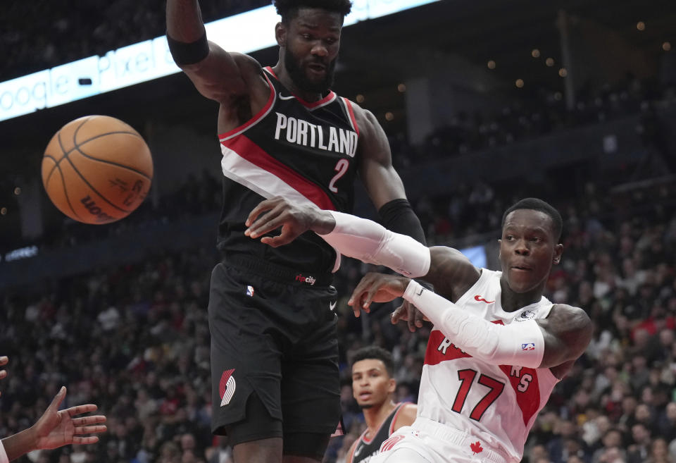 Toronto Raptors guard Dennis Schroder (17) moves the ball around Portland Trail Blazers center Deandre Ayton (2) during first-half NBA basketball game action in Toronto, Monday, Oct. 30, 2023. (Nathan Denette/The Canadian Press via AP)