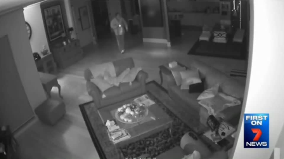 A thief nonchalantly walks around a mansion at night. Photo: 7 News