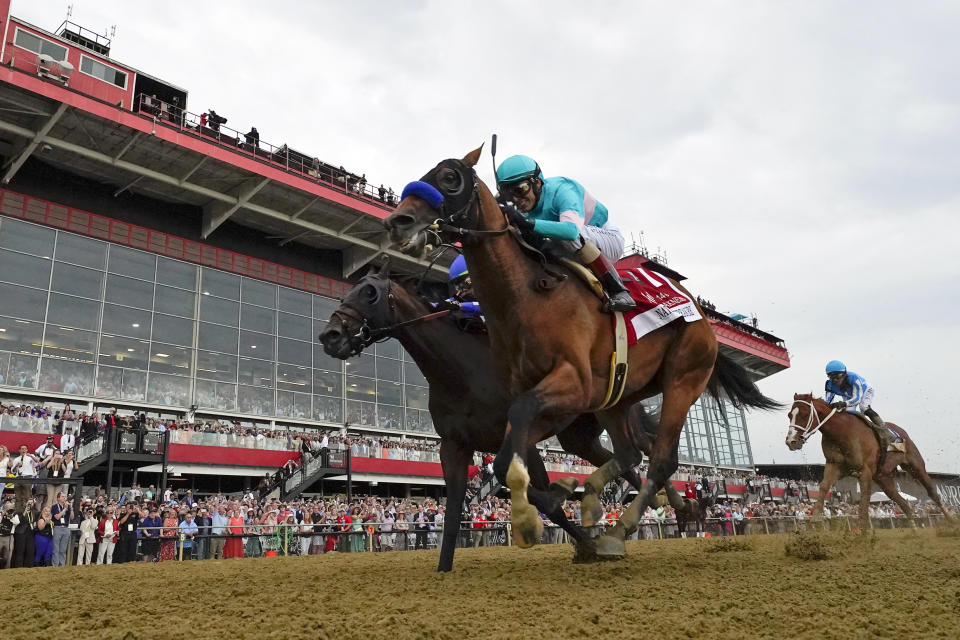National Treasure, with jockey John Velazquez, edges out Blazing Sevens, with jockey Irad Ortiz Jr., to win the148th running of the Preakness Stakes horse race at Pimlico Race Course, Saturday, May 20, 2023, in Baltimore. Kentucky Derby winner Mage, right, finished third. (AP Photo/Julio Cortez)