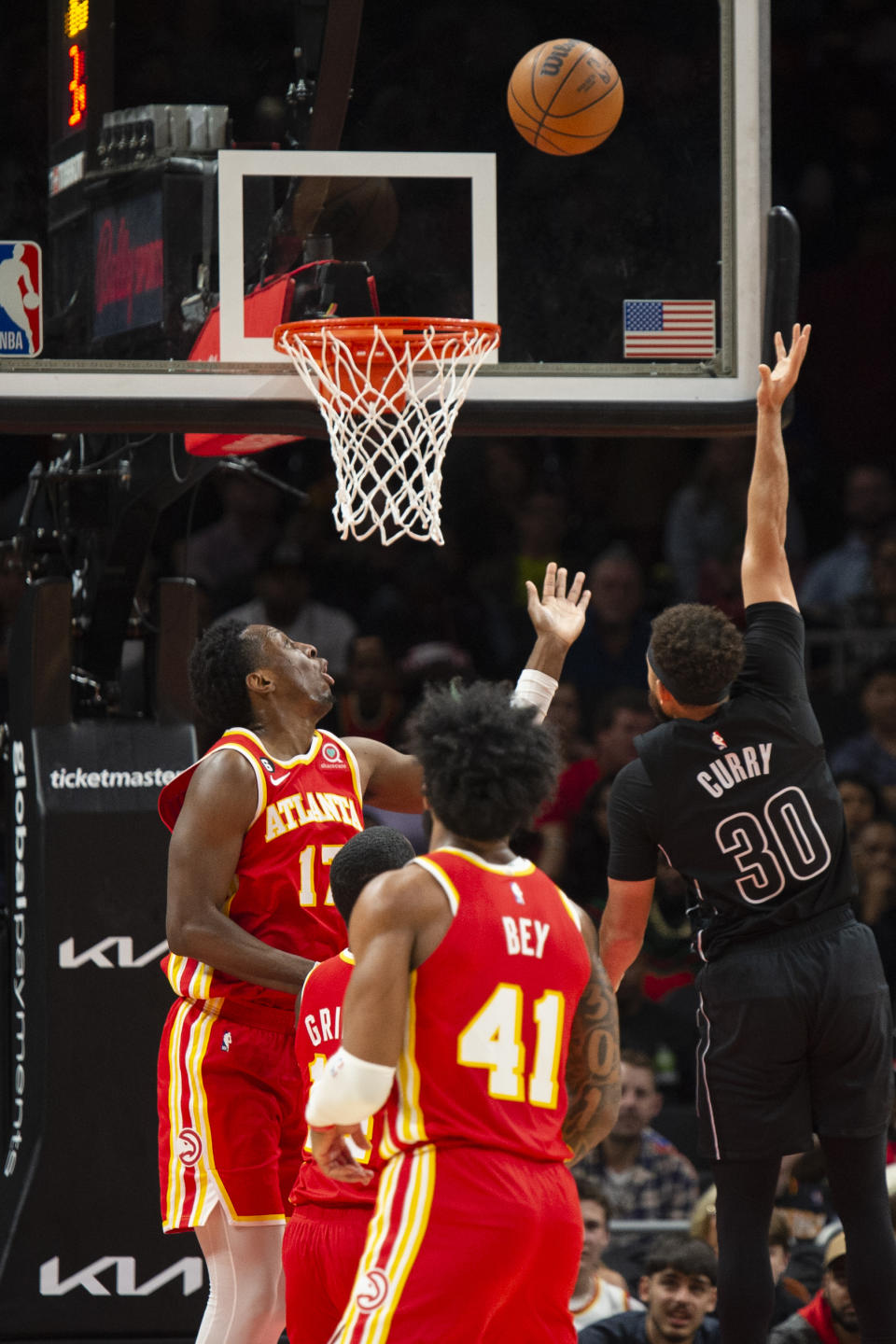 Brooklyn Nets guard Seth Curry (30) shoots against Atlanta Hawks forward Onyeka Okongwu during the first half of an NBA basketball game, Sunday, Feb. 26, 2023, in Atlanta. (AP Photo/Hakim Wright Sr.)