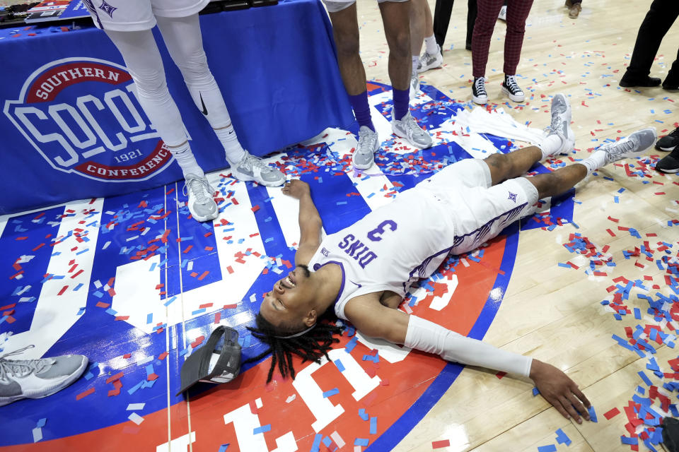 Furman guard Mike Bothwell celebrates his team's win over Chattanooga for the NCAA men's college basketball championship game for the Southern Conference tournament, Monday, March 6, 2023, in Asheville, N.C. (AP Photo/Kathy Kmonicek)