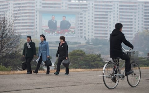 Kim Jong-il and Kim Il-sung look down upon the population from across the captial - Credit: Eddie Mulholland