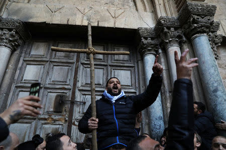 Worshippers shout slogans during a protest in front of the closed doors of the Church of the Holy Sepulchre in Jerusalem's Old City, February 27, 2018. REUTERS/Ammar Awad