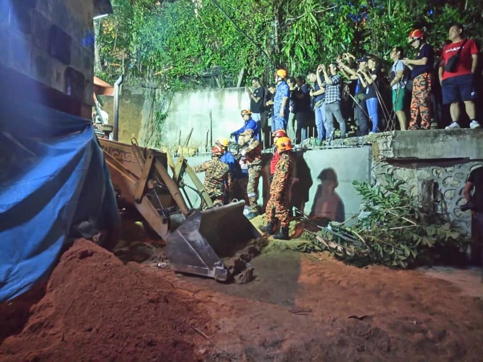 Fire and Rescue Department personnel search for victims of a landslide in Tanjung Bungah, George Town June 25, 2019. — Picture courtesy of the Penang police