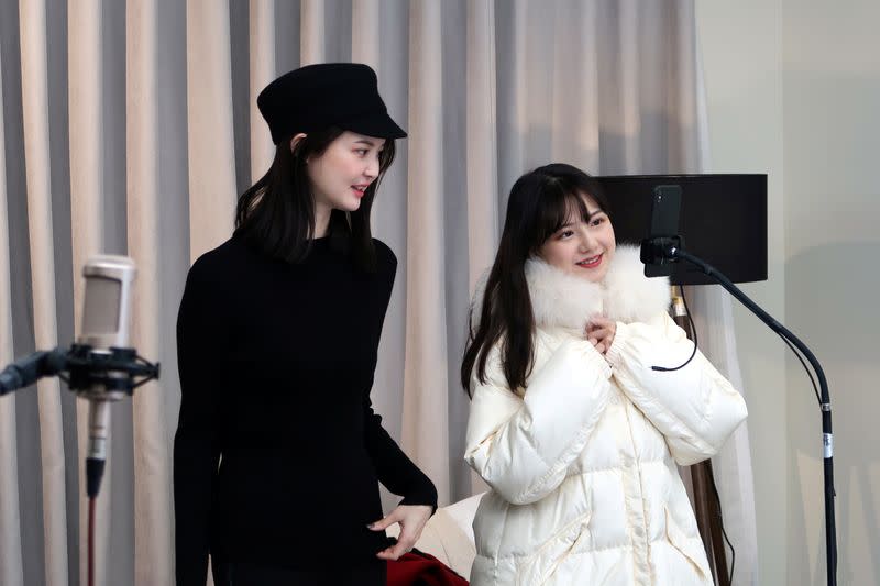 Live-streaming anchors promote clothing during a live-streaming session for "Double 12" in Hangzhou