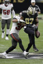 New Orleans Saints tight end Jared Cook (87) fumbles the ball as he is hit by Tampa Bay Buccaneers strong safety Antoine Winfield Jr., left, during the second half of an NFL divisional round playoff football game, Sunday, Jan. 17, 2021, in New Orleans. The Buccaneers' Devin White recovered the ball. (AP Photo/Butch Dill)