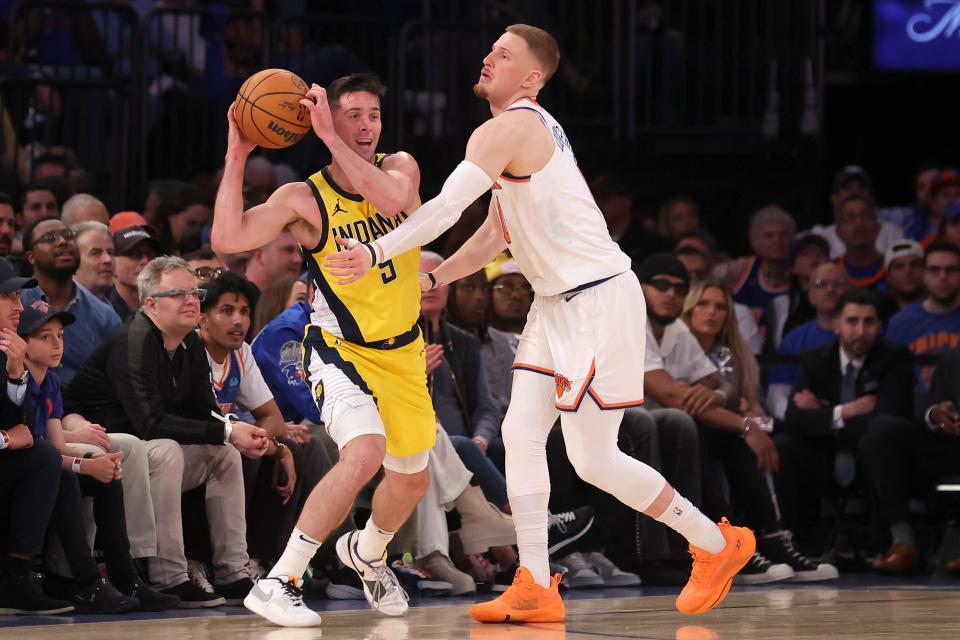 May 6, 2024; New York, New York, USA; Indiana Pacers guard T.J. McConnell (9) looks to pass the ball against New York Knicks guard Donte DiVincenzo (0) during the second quarter of game one of the second round of the 2024 NBA playoffs at Madison Square Garden. Mandatory Credit: Brad Penner-USA TODAY Sports