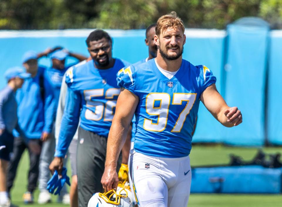 Chargers outside linebackers Khalil Mack (52) and Joey Bosa (97) walk off the field during minicamp in June.