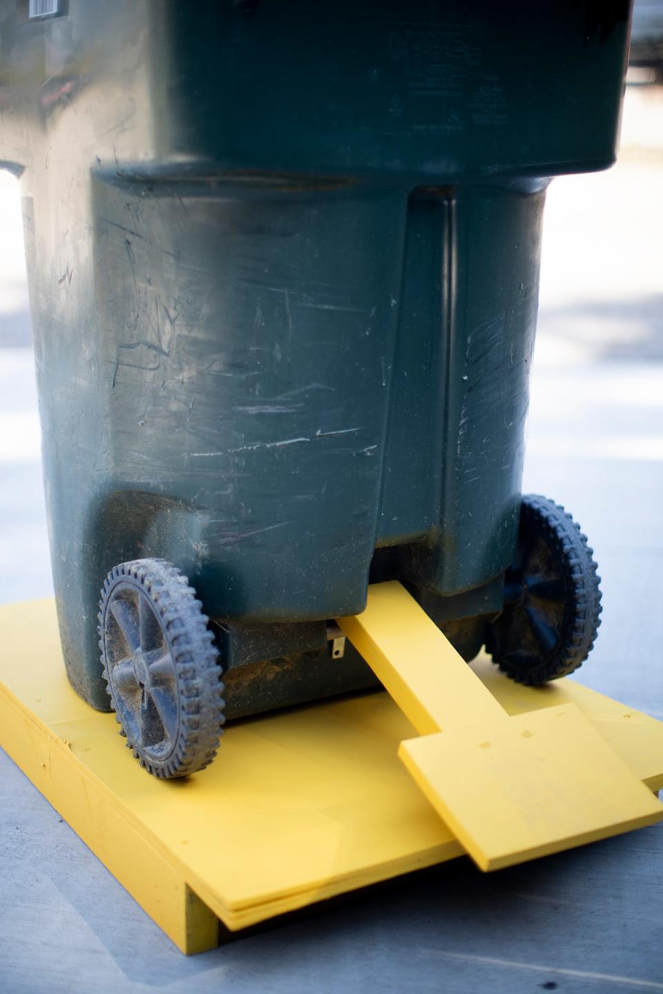 Damian Earley received a patent from U.S. Patent and Trademark Office for The Garbage Lot, a locking platform that uses sand or water to weigh down a garbage or recycling receptacle and prevent bins from tipping over and spilling debris into the street.