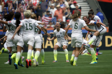 Jul 5, 2015; Vancouver, British Columbia, CAN; United States midfielder Lauren Holiday (12) celebrates with teammates after defeating Japan in the final of the FIFA 2015 Women's World Cup at BC Place Stadium. Mandatory Credit: Michael Chow-USA TODAY Sports