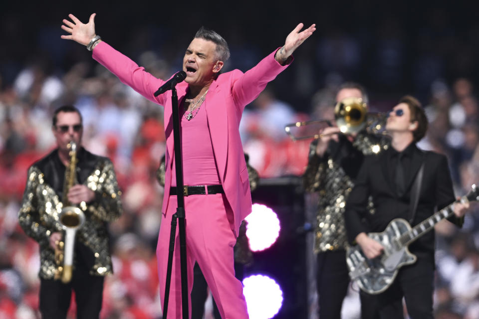 Entertainer Robbie Williams performs ahead of the AFL Grand Final match between the Geelong Cats and the Sydney Swans at the Melbourne Cricket Ground in Melbourne, Australia, Saturday, Sept. 24, 2022. (James Ross/AAP Image via AP)
