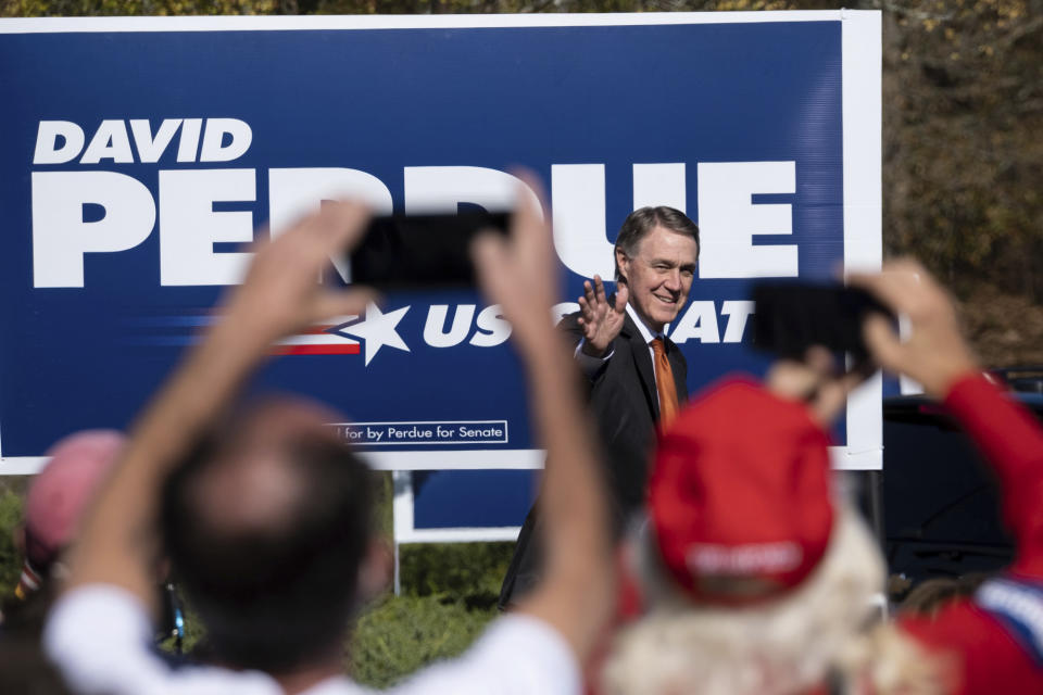 FILE - In this Nov. 20, 2020, file photo Sen. David Perdue, R-Ga., takes the stage before Vice President Mike Pence during a Defend the Majority Rally in Canton, Ga. (AP Photo/Ben Gray, File)