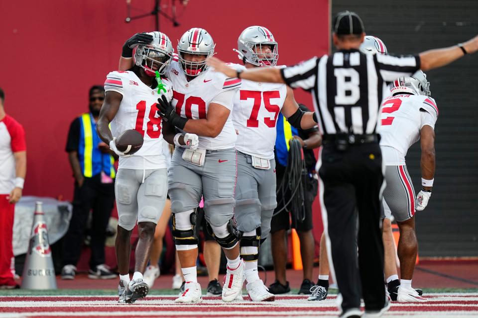 Ohio State receiver Marvin Harrison Jr. (18) celebrates a big play with tackle Josh Fryar (70) against Indiana.