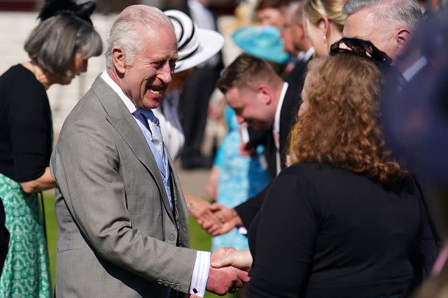 <p>JORDAN PETTITT/POOL/AFP via Getty Images</p> King Charles at a Buckingham Palace garden party on May 8, 2024.