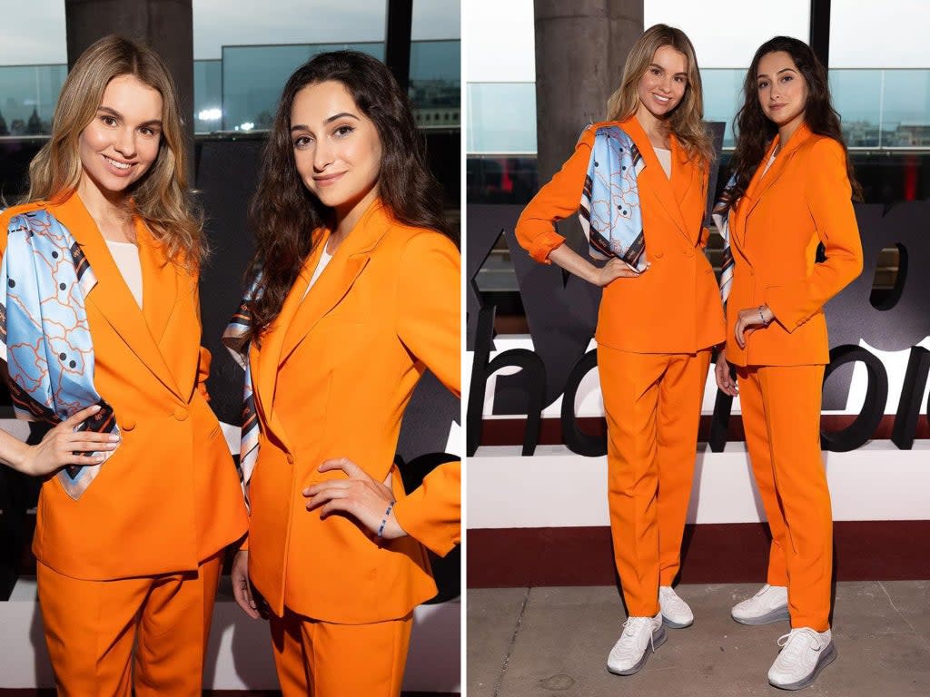 The new SkyUp uniform features a slouchy orange trouser suit and smart white trainers (SkyUp/Instagram)