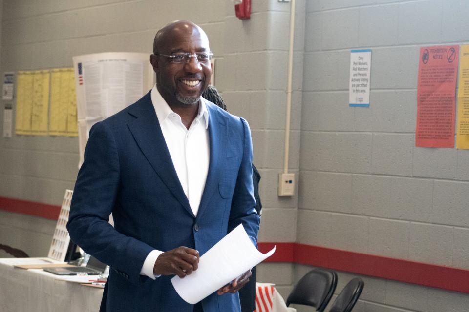 Sen. Raphael Warnock, D-Ga., casts his ballot on the first day of early voting on Oct. 17, 2022, in Atlanta.