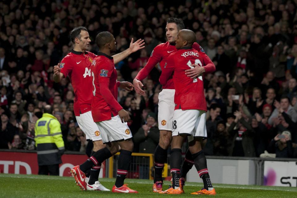 Manchester United's Robin van Persie, second right, celebrates with teammates after scoring against Cardiff City during their English Premier League soccer match at Old Trafford Stadium, Manchester, England, Tuesday Jan. 28, 2014. (AP Photo/Jon Super)