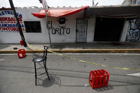 A view at a crime scene where unknown assailants shot and killed three people in Llano Redondo neighborhood in Mexico City, Mexico, July 23, 2017. REUTERS/Edgard Garrido