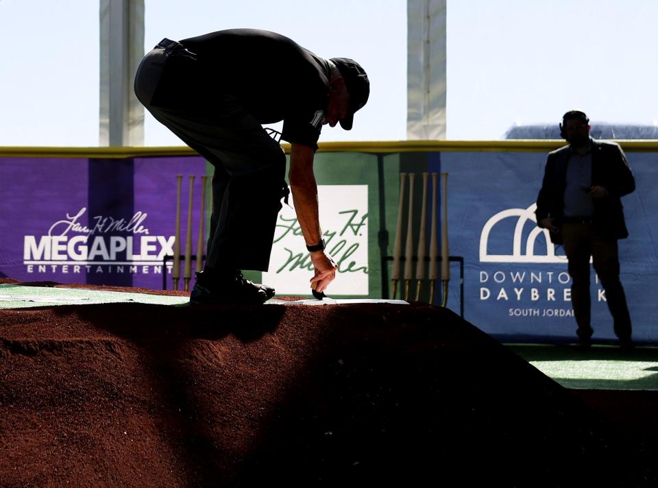 Retired baseball umpire Gerry Leonard clears off home plate during the celebration and groundbreaking event of the new Salt Lake Bees ballpark and Phase 1 of Downtown Daybreak in South Jordan on Thursday, Oct. 19, 2023. | Laura Seitz, Deseret News