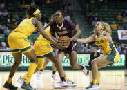 Texas State guard Sierra Dickson, center, is fouled by Baylor forward NaLyssa Smith, left, while driving past guard Jaden Owens in the first half of an NCAA college basketball game, Tuesday, Nov. 9, 2021, in Waco, Texas. (Rod Aydelotte/Waco Tribune-Herald via AP)