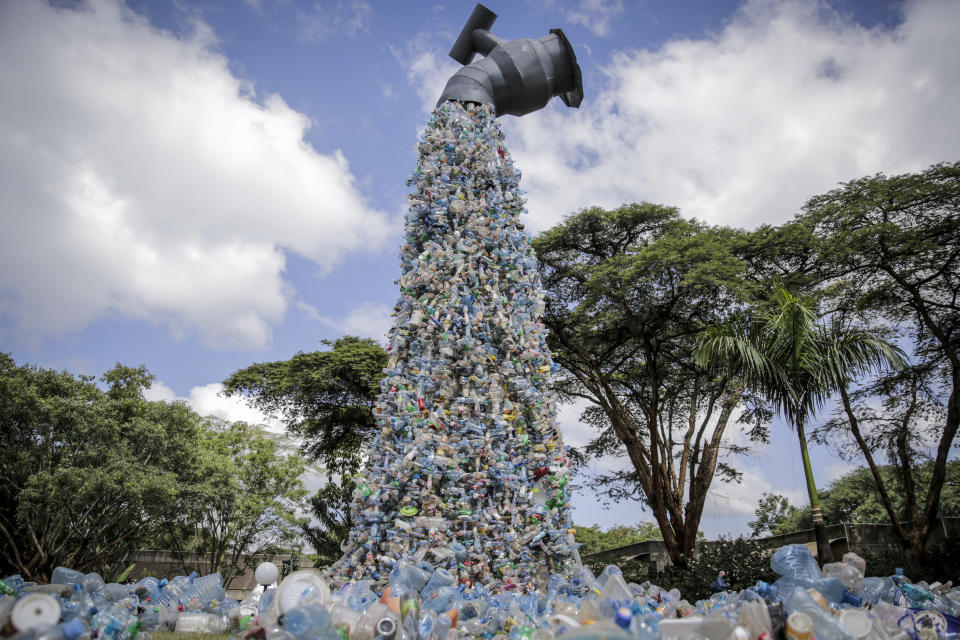 A giant art sculpture showing a tap outpouring plastic bottles, each of which was picked up in the neighborhood of Kibera, during the U.N. Environment Assembly (UNEA) held at the U.N. Environment Programme (UNEP) headquarters in Nairobi, Kenya Wednesday, March 2, 2022. Delegates met to discuss a binding international framework to address the growing problem of plastic waste in the world's oceans, rivers and landscape. (AP Photo/Brian Inganga)