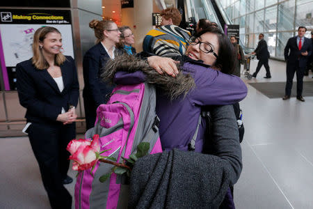 Samira Asgari is greeted by a friend after she cleared U.S. customs and immigration in Boston, Massachusetts, U.S. February 3, 2017. Asgari is an Iranian scientist who had obtained a visa to conduct research at Brigham and Women's Hospital and was twice prevented from entering the United States under President Trump's executive order travel ban. REUTERS/Brian Snyder