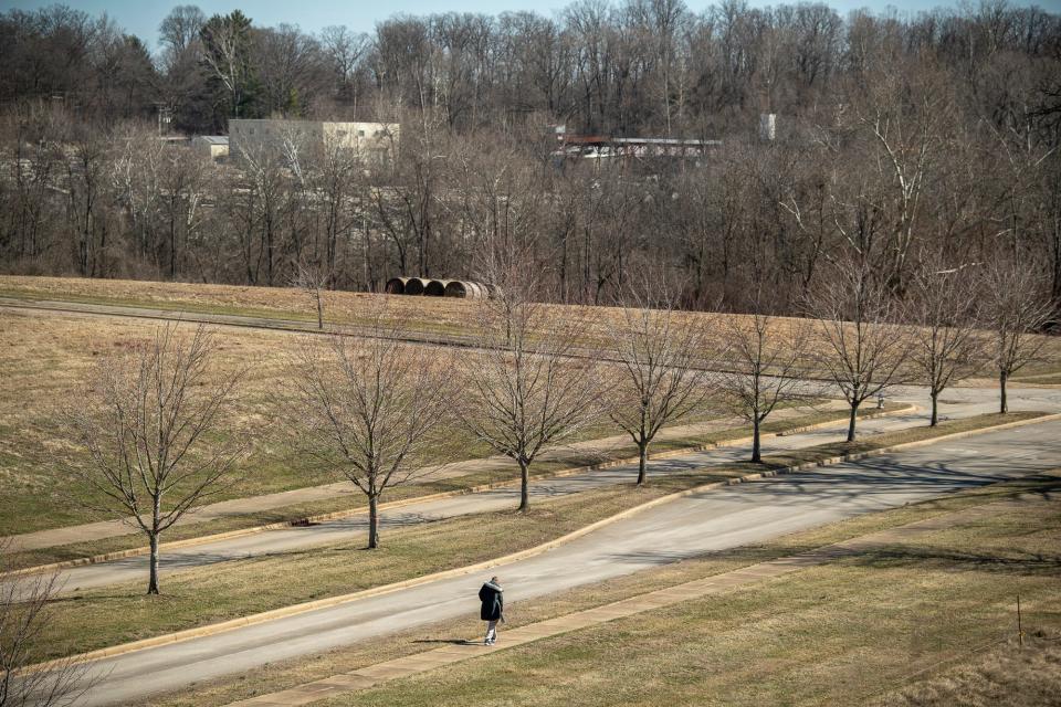 A man walks on the sidewalk along Hunter Valley Road, near the area Monroe County commissioners are exploring for a new county jail, on Thursday, Feb. 29, 2024.