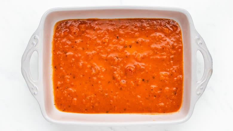 Red enchilada sauce in baking dish