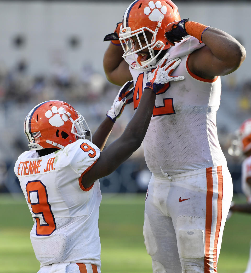 Clemson running back Travis Etienne (9) celebrates his touchdown against Georgia Tech with Clemson's Christian Wilkins during the second half of an NCAA college football game, Saturday, Sept. 22, 2018, in Atlanta. (AP Photo/Mike Stewart)