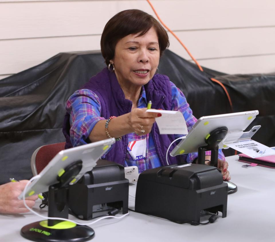 Evelyn Aguila checks in voters at St. Catharine's in Blauvelt Nov. 7, 2023.