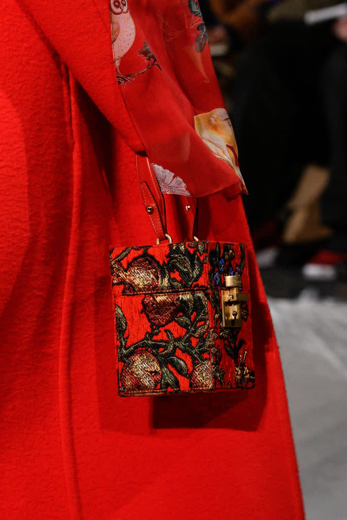 <p>A model carries a red floral-print cube bag from the Oscar de la Renta FW18 show. (Photo: Getty Images) </p>