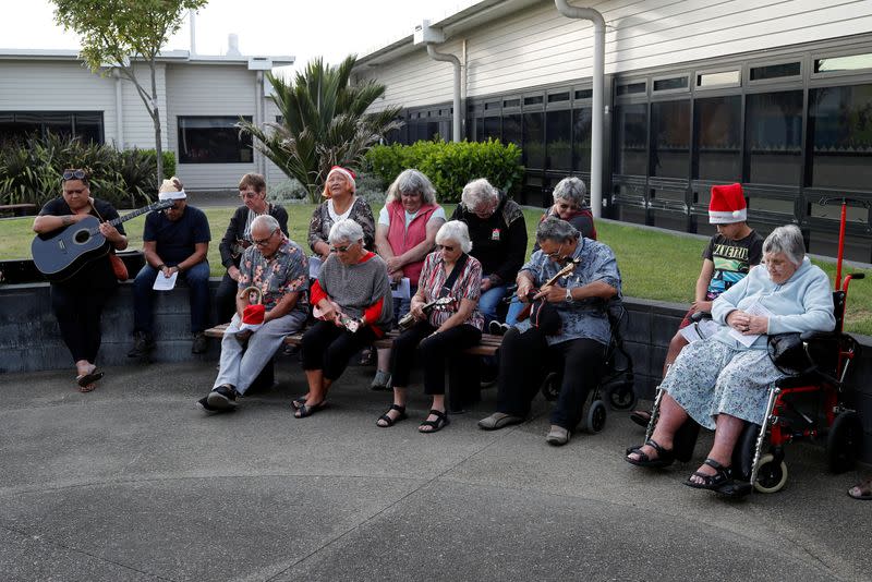 People observe a minute of silence as the pay their respects to the victims of the White Island volcano eruption, at the hospital in Whakatane