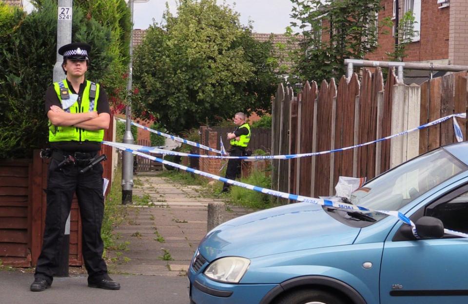 Police officers at the scene in Naburn Fold, in the Whinmoor area of Leeds (PA) (PA Wire)