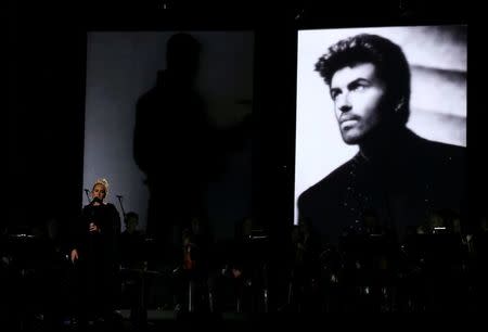 Singer Adele performs a tribute to the late George Michael (on screen) at the 59th Annual Grammy Awards in Los Angeles, California, U.S. , February 12, 2017. REUTERS/Lucy Nicholson