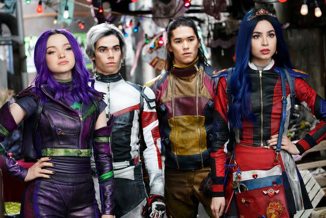 <p>Everett Collection</p> Dove Cameron, Cameron Boyce, Booboo Steward, and Sofia Carson in 'Descendants'